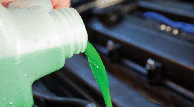 liquid being poured into a coolant system