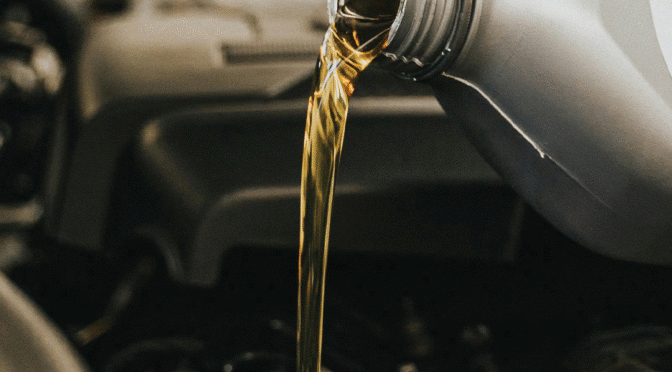 Oils being poured into an engine